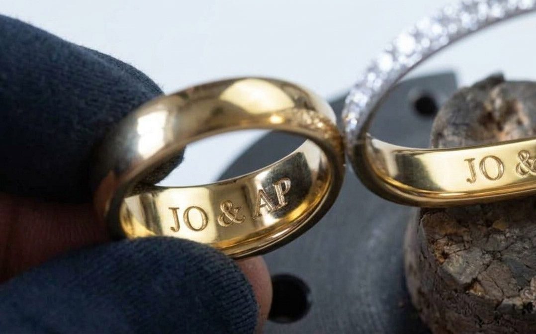 Two gold wedding rings engraved with initials